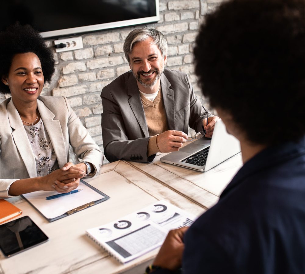 Business recruiters talking with candidate during job interview.